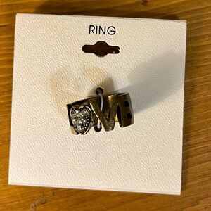 Sweetheart love ring in gold tone with the word “LOVE” new on card size 7 1/2